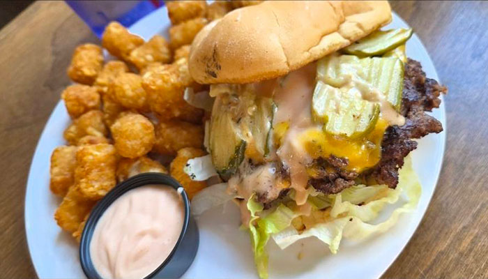 The 208 Bar & Grill Specials: Cheeseburger with pickles, lettuce, tater tots, and dipping sauce.