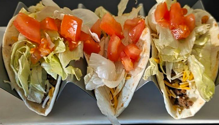 Three soft tacos filled with ground beef, lettuce, cheese, and tomatoes—The 208 Bar & Grill Specials.